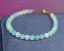 - Dainty Ethiopian Opal Sphere Bracelet in Gold Filled