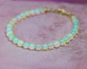 - Dainty Ethiopian Opal Sphere Bracelet in Gold Filled
